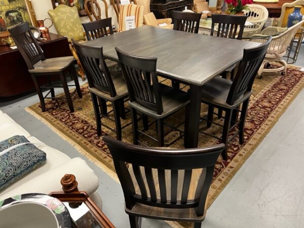 A Black Dining Table with Chairs Image