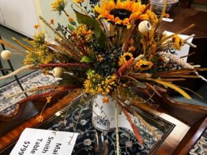 floral arrangement in white pitcher